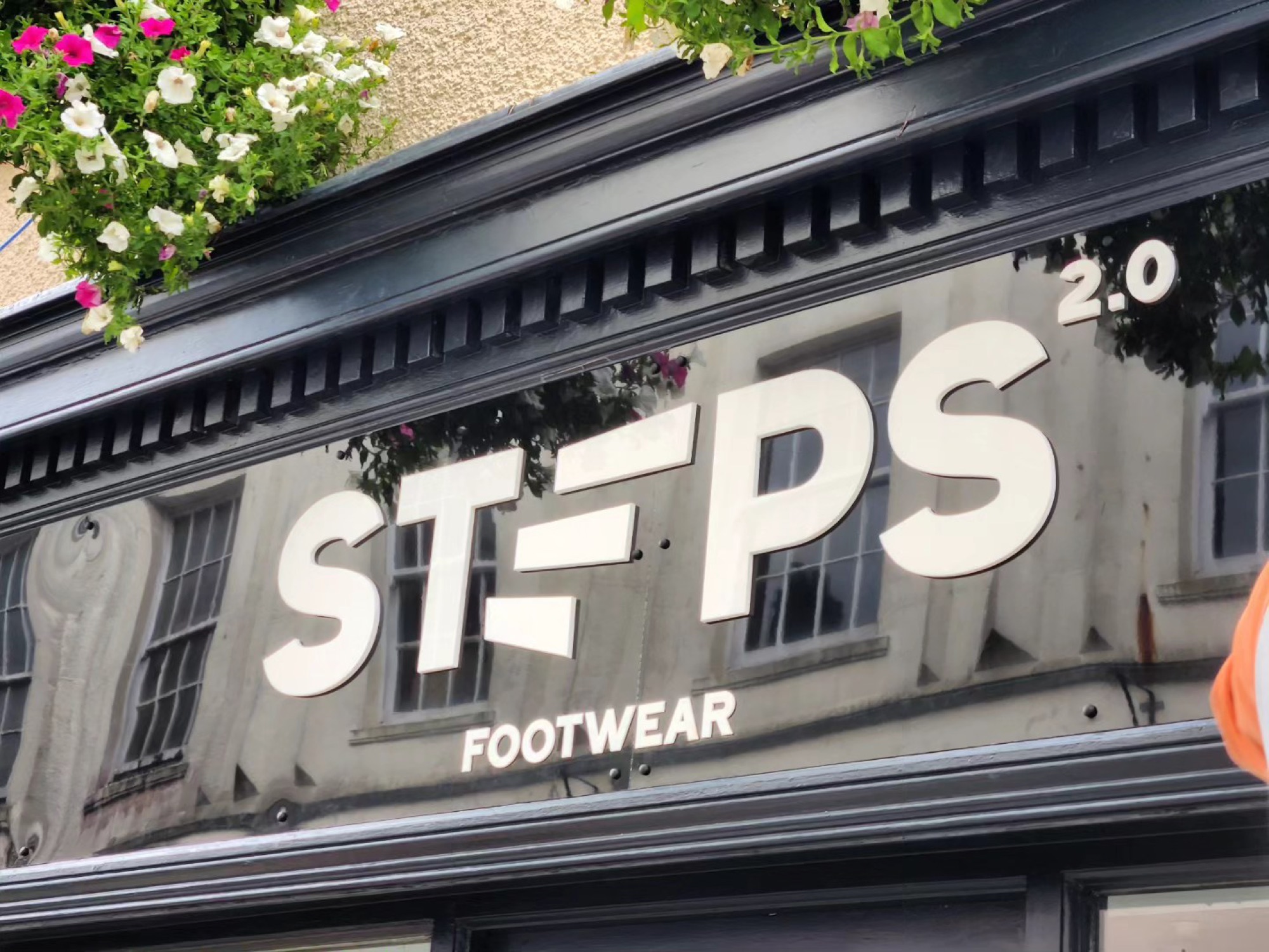 Fascia, close-up — white letterforms with cyan slash marks against black