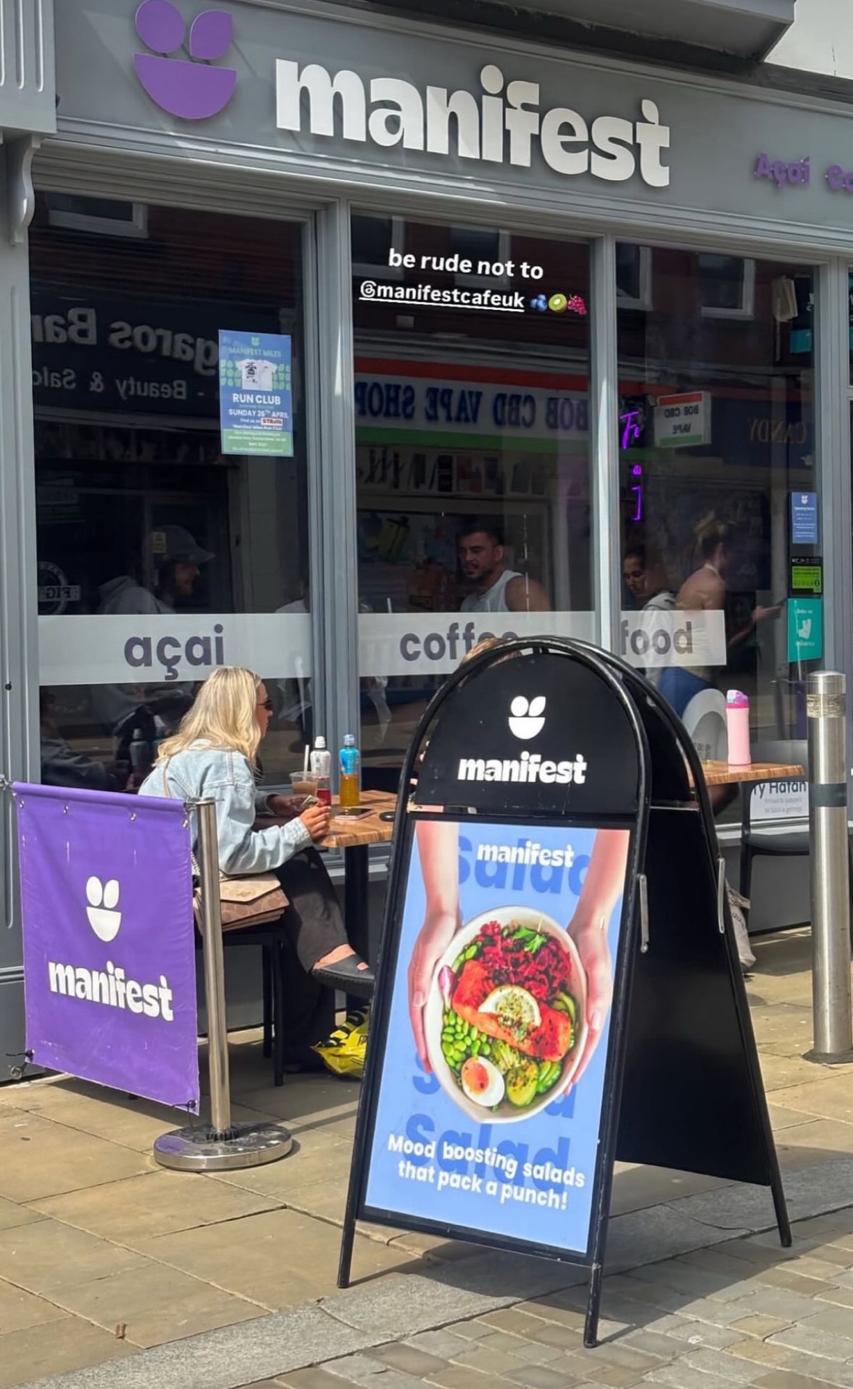Manifest store front with branded A-board on the high street