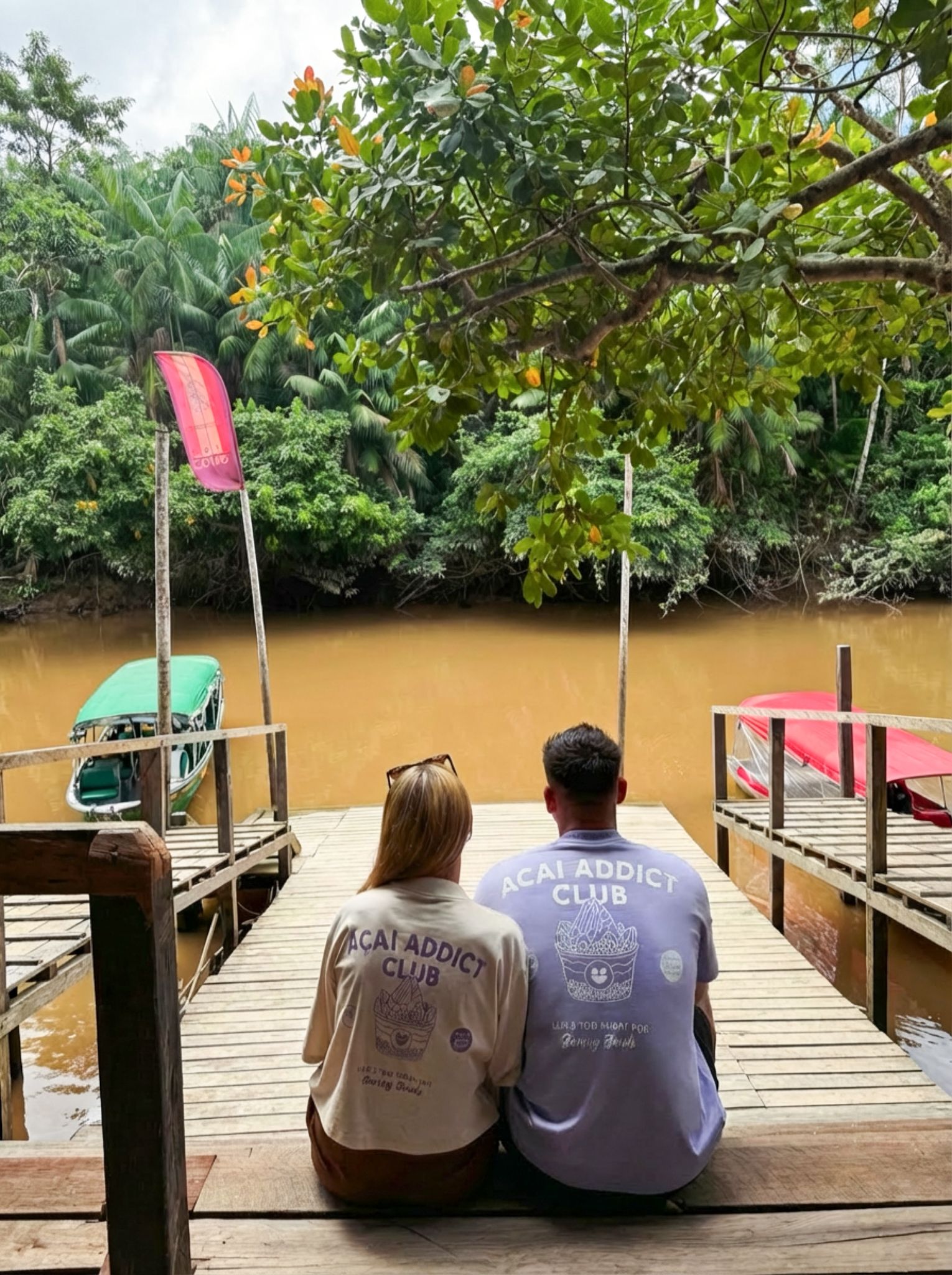 Manifest team on a dock in the Brazilian Amazon wearing Açaí Addict Club tees