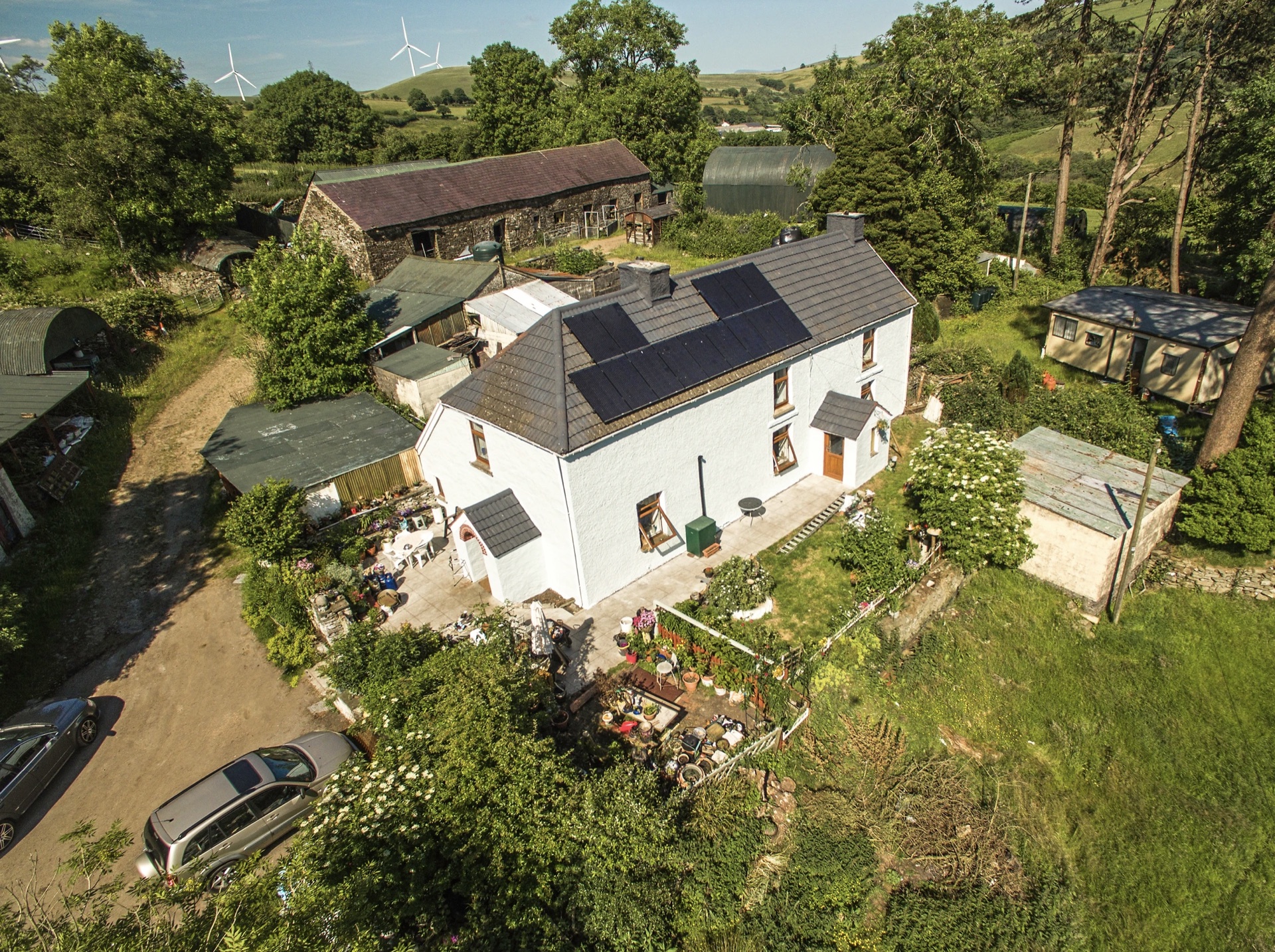 Aerial — farmhouse renovation, hillside